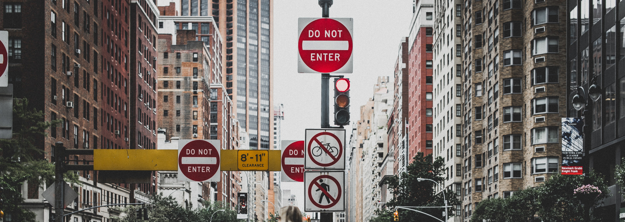 A city street with multiple "do not enter" signs.