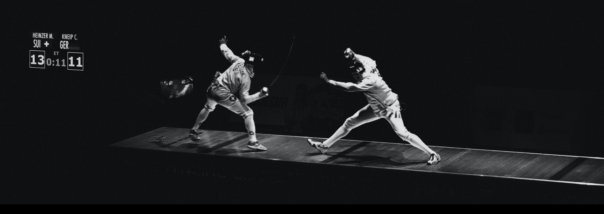 Two people in a fencing match