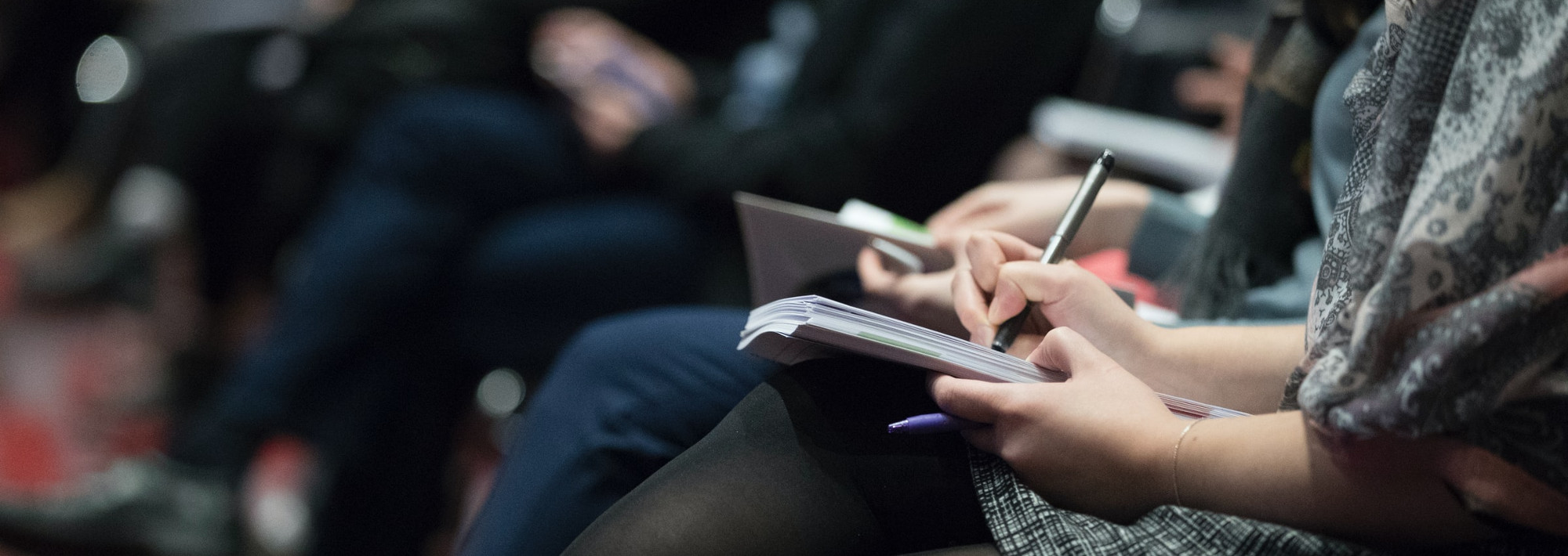 Students attending a lecture and taking notes